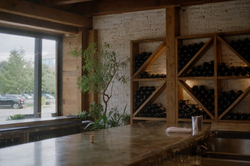 A tasting room with a bar and wine bottles
