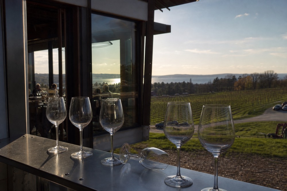 A row of wine glasses catching afternoon light inside a peninsula tasting room