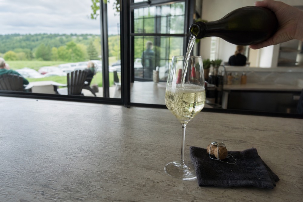 Sparkling wine being poured into tasting glasses at a small Michigan winery