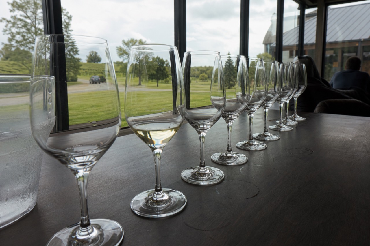 A row of wine glasses on a Leelanau Peninsula tasting room bar