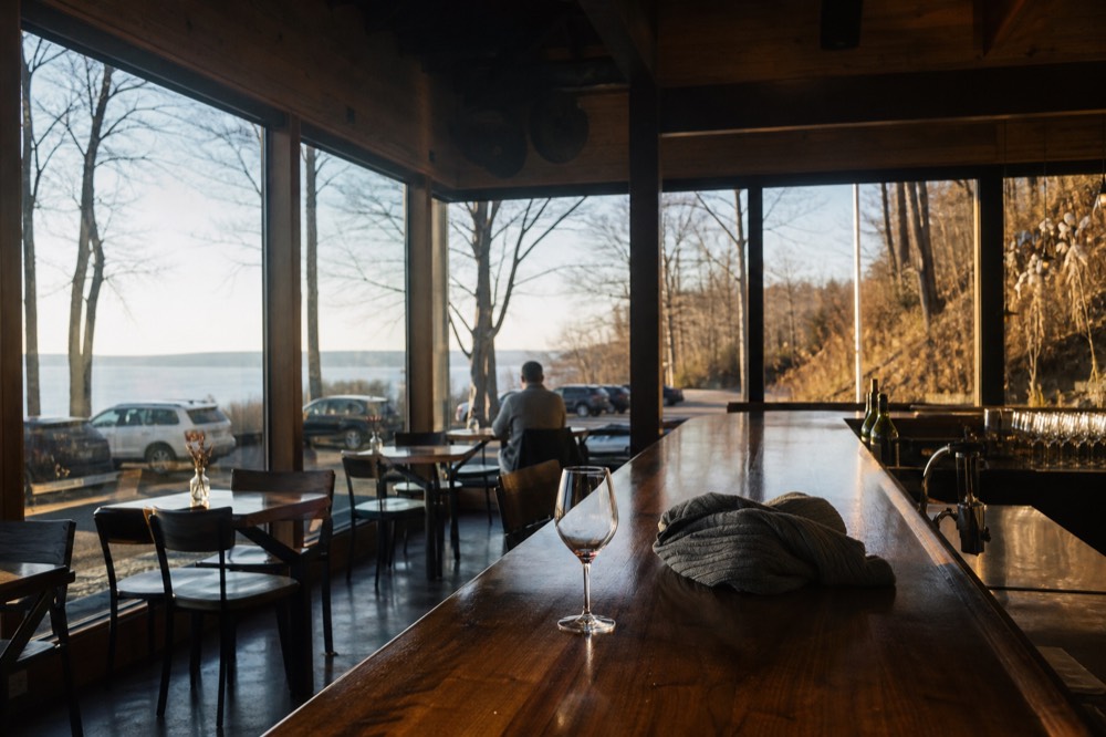 A quiet tasting room bar with autumn light through the windows