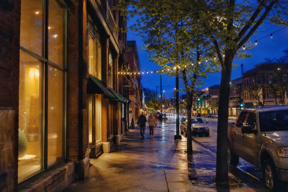 Downtown Traverse City street with storefronts and evening light