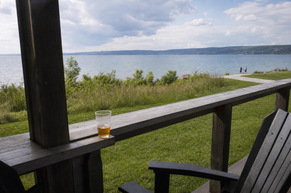 A tasting room patio overlooking calm bay water between two peninsulas