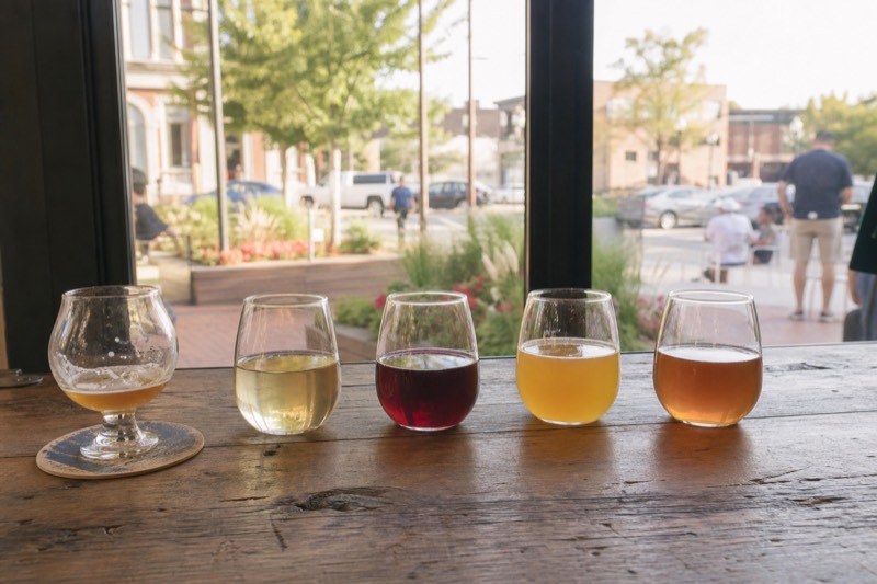 A tasting flight of wine, cider and beer lined up on a bar in northern Michigan