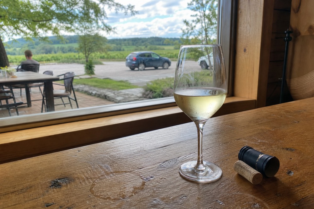 Close-up of a glass of pale gold Riesling on a tasting counter
