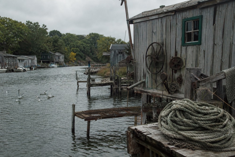 Weathered fishing shanties along a river in a small lake town