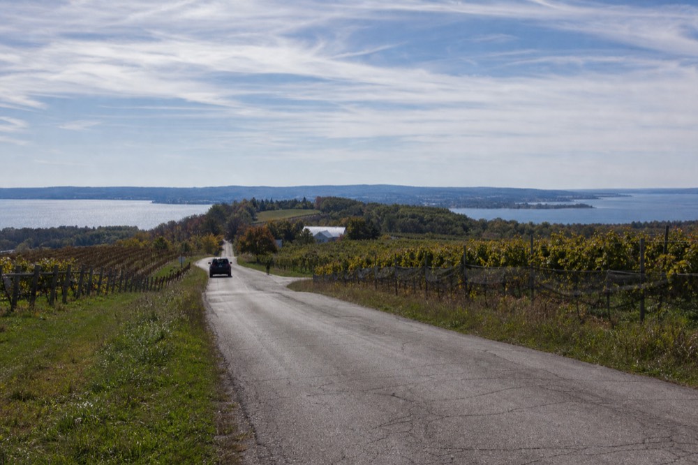 Center Road on Old Mission Peninsula with vineyards and bay water on both sides