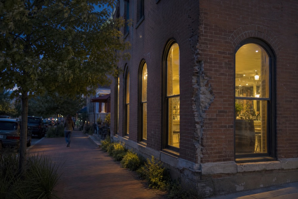 A historic brick village building housing an urban winery tasting room