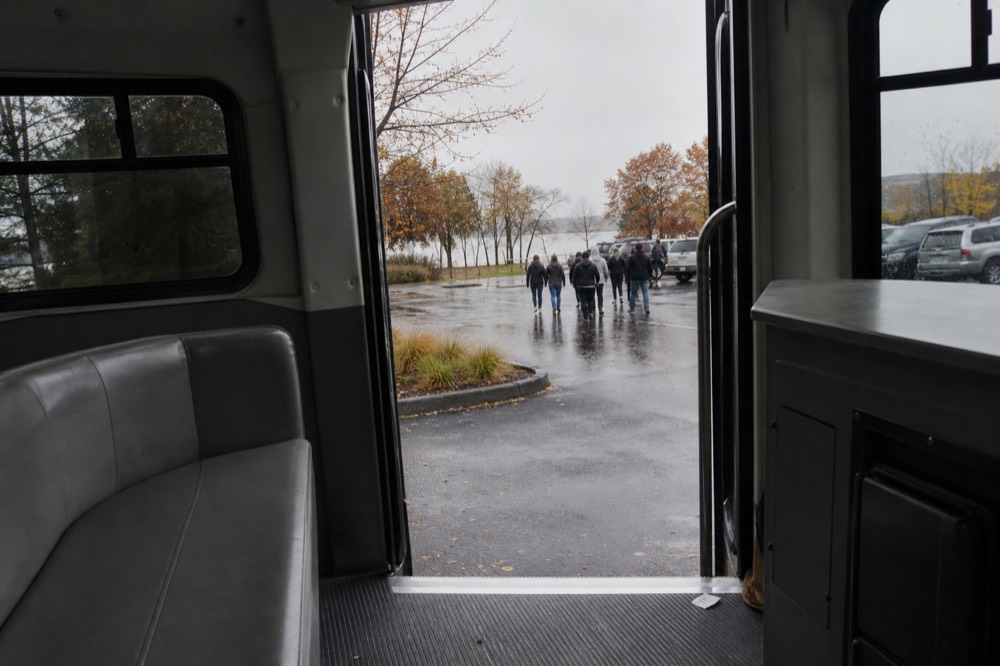 A chauffeur-style shuttle interior with seating and a small counter